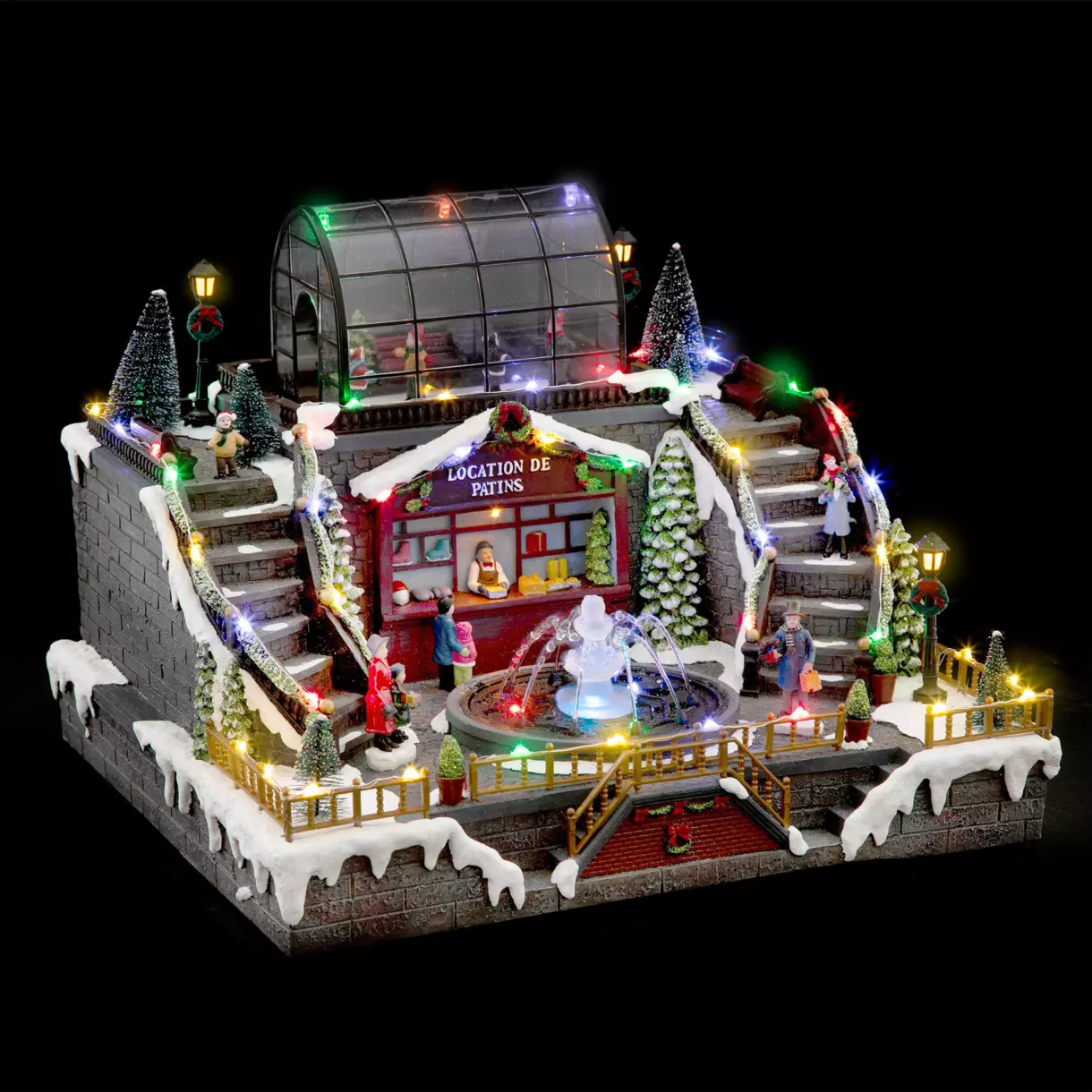Pueblo de Navidad luminoso Pista de hielo y fuente
