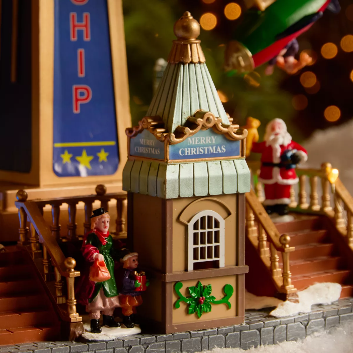 Pueblo de Navidad luminoso, animado y musical (H47 cm) Carrusel de aviones