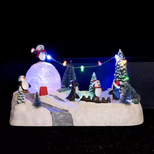 Escena de vida iluminada Parque infantil de los ping�inos a pilas 